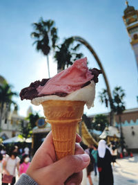 Cropped hand holding ice cream cone