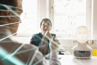 Side view of woman using mobile phone