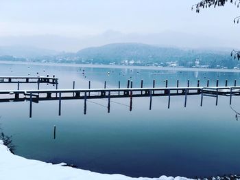 Scenic view of lake against sky during winter