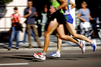 Low section of people running in marathon