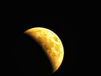 Close-up of orange slice against black background