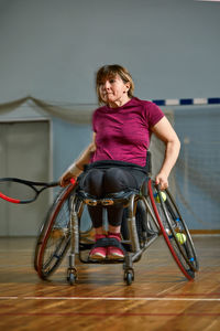 Portrait of young woman sitting on wheelchair