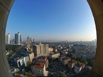 High angle view of cityscape against clear sky seen from window