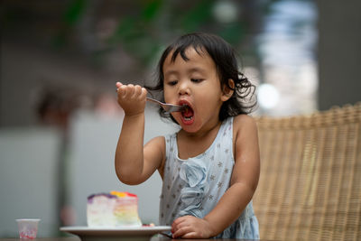 Girl eating sweat food on table