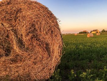 Hay bales on field against sky