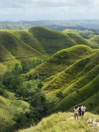 High angle view of hikers walking on mountain