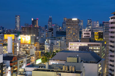 Illuminated buildings in city at night