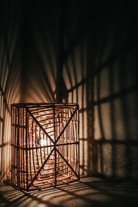 Close-up of illuminated light bulb in cage