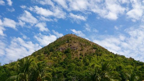 Low angle view of mountain against cloudy sky