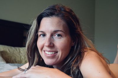 Close-up of young woman at home smiling