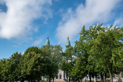 Panoramic view of trees and buildings against sky