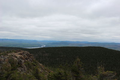 Scenic view of mountains against cloudy sky