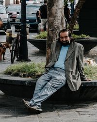 Portrait of young man sitting outdoors