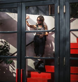 Portrait of woman standing by railing