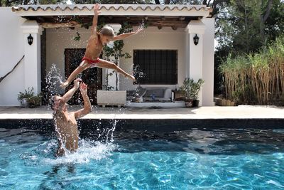 Father and daughter playing in swimming pool