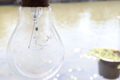 Close-up of woman light bulb on table