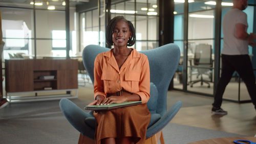 Portrait of young woman using mobile phone