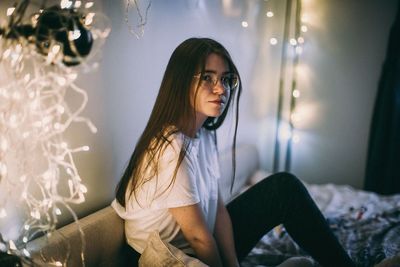 Portrait of woman in illuminated room