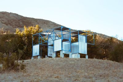 Built structure on beach against clear sky