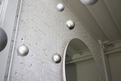 Low angle view of pendant lights hanging on ceiling of building