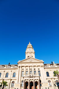 Low angle view of building against blue sky