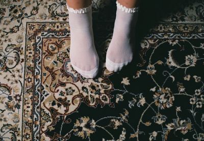 Low section of woman standing on floor