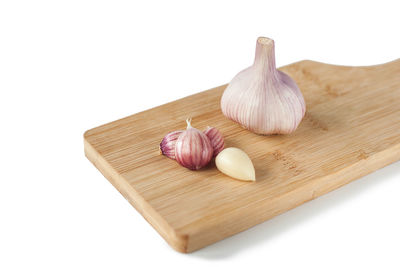 Close-up of bread on cutting board against white background