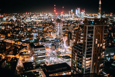 Aerial view of city lit up at night