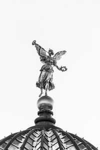 Low angle view of statue against sky