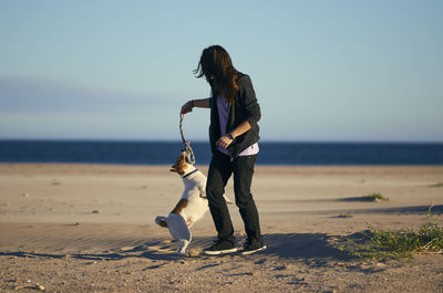 Full length of woman on beach against sky