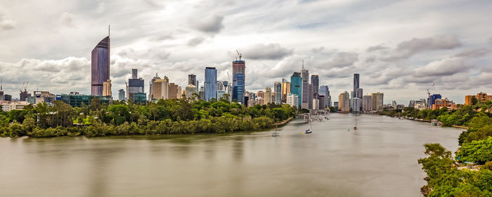 Panoramic view of city against cloudy sky