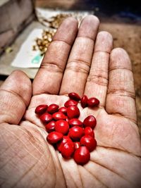 Close-up of hand holding red candies