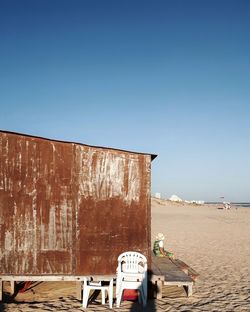 Built structure on beach against clear blue sky