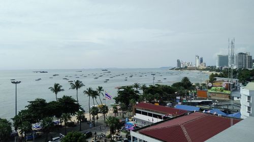 High angle view of sea and buildings against sky