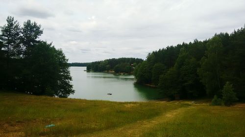 Scenic view of lake against cloudy sky