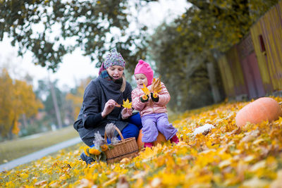 Mother and child in autumn leaves