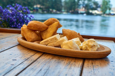 Fluffy fritters and white domestic cheese and cream served served outdoor
