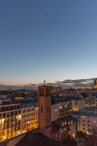 High angle view of city buildings against clear sky