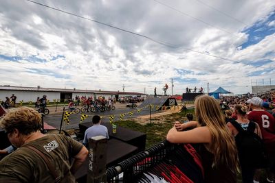 Group of people enjoying music concert against sky