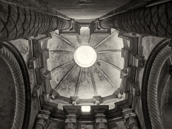 Low angle view of illuminated lamp in building