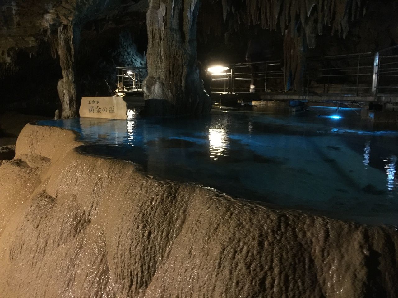 water, night, built structure, architecture, building exterior, illuminated, beach, sand, reflection, sea, shore, waterfront, outdoors, nature, sky, transportation, no people, incidental people, nautical vessel, rock - object