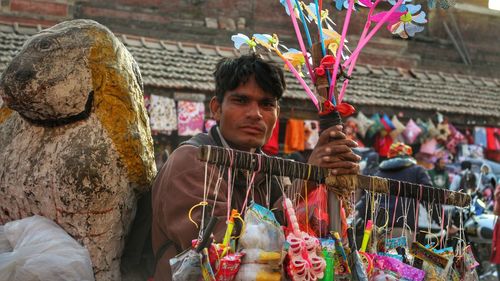 Portrait of young man holding skateboard