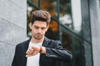 Young businessman checking time