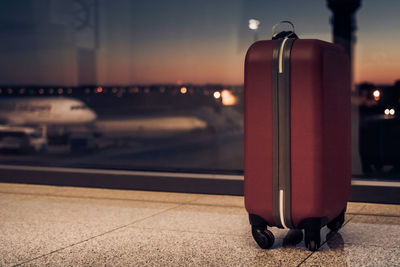 Close-up of suitcase at airport terminal 