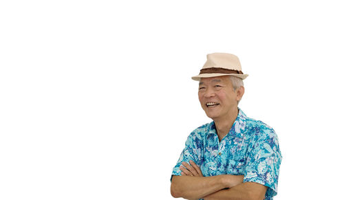 Portrait of smiling man standing against white background