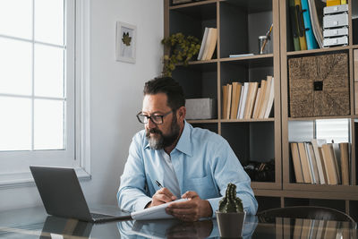 Man using laptop while sitting at home