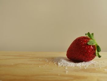 Close-up of strawberry on table against white background