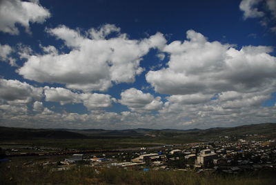 Scenic view of mountains against cloudy sky