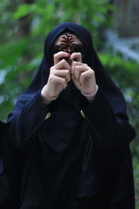 Low section of woman standing on covering face