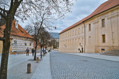 People walking on street amidst buildings in city